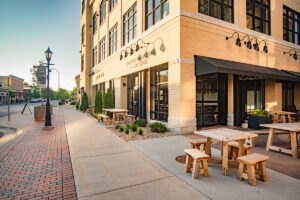 Exterior of Coffee Roasters and Kitchen at Middleton Center with outdoor bench seating and brick facade
