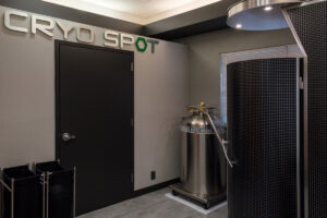 Cryo Spot room at Carbon World Health with cryotherapy chamber and dimensional wall signage